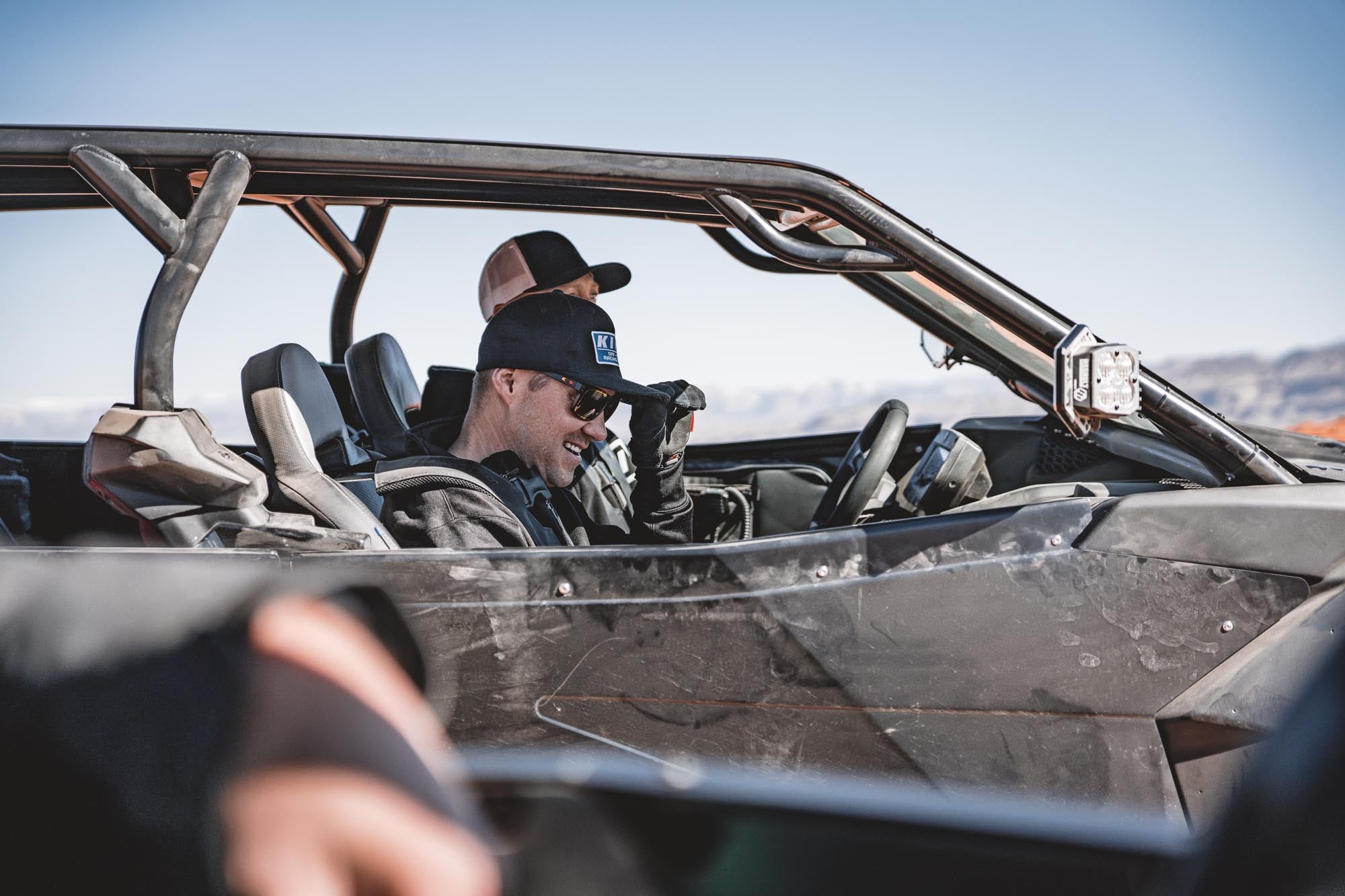 Man enjoying offroading utv smiling canam x3 maverick hat